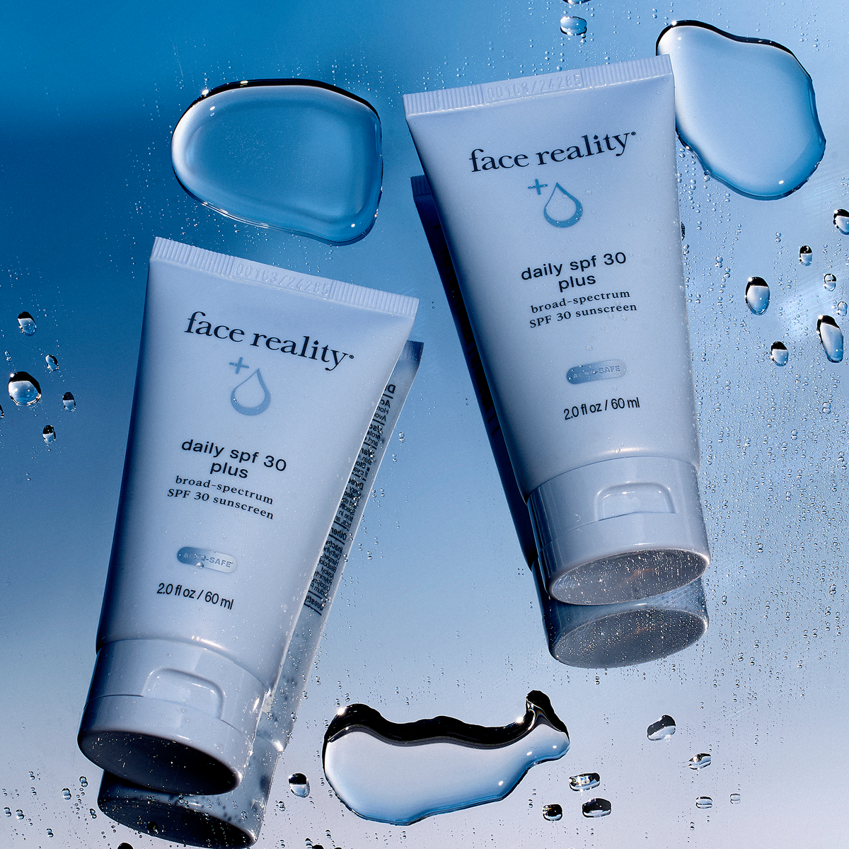 Two tubes of Face Reality Daily SPF 30 Plus on a blue surface